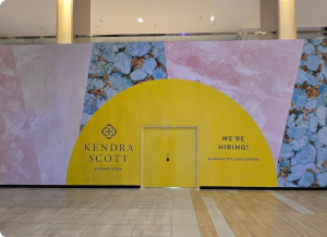 Branded barricade graphics wrapping a construction hoarding wall